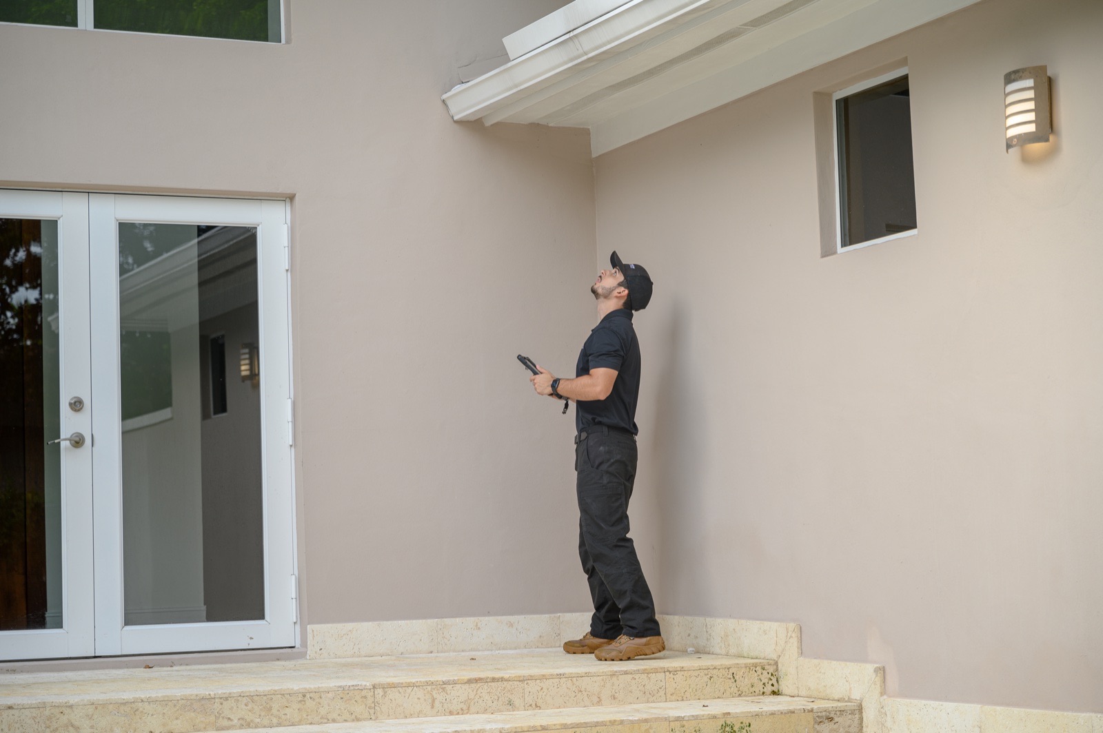 TruView Inspections inspector performing a wind mitigation inspection to help a Miami homeowner qualify for insurance discounts